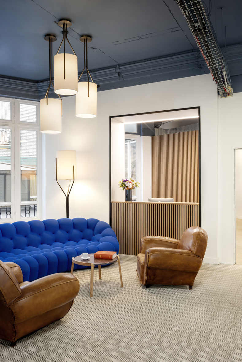 Espace d’accueil du projet Ternes à Paris avec suspensions Arborescence et comptoir sur mesure en bois